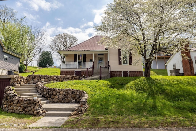 207 Loomis St, Tellico Plains, TN 37385 - view of front facade with a front yard, a porch, and metal roof