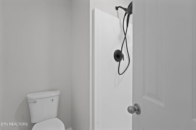 bathroom featuring toilet and a shower
