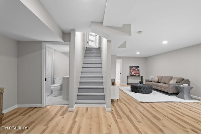living room featuring recessed lighting, baseboards, stairway, and wood finished floors