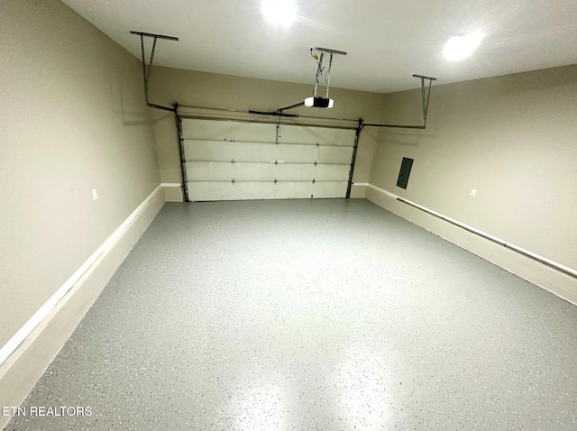 garage with baseboards and a garage door opener