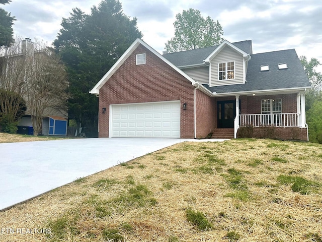 traditional home with a porch, an attached garage, concrete driveway, brick siding, and a front lawn