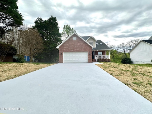 view of front of home featuring an attached garage, covered porch, brick siding, a front lawn, and driveway
