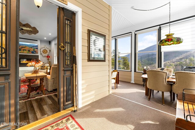 sunroom / solarium featuring a mountain view