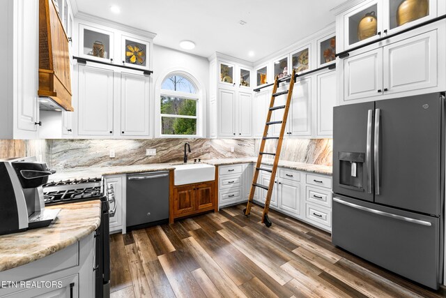 kitchen with fridge with ice dispenser, dishwasher, a sink, gas range oven, and white cabinetry