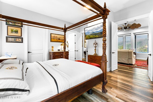 bedroom featuring wood finished floors and baseboards