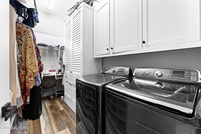 laundry area featuring cabinet space, washer and dryer, and dark wood-style flooring