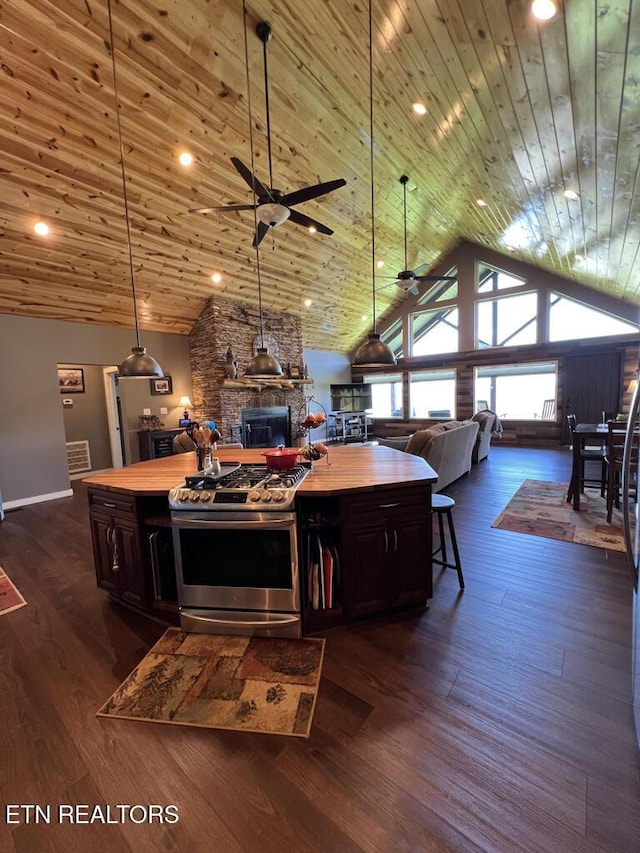 interior space featuring a ceiling fan, dark wood finished floors, lofted ceiling, and wooden ceiling