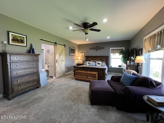 carpeted bedroom with baseboards, ceiling fan, recessed lighting, a barn door, and connected bathroom