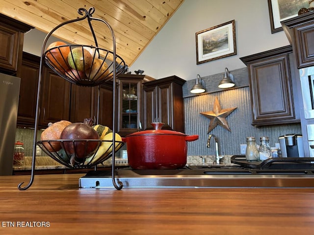 details with dark brown cabinets, bar, and wood ceiling