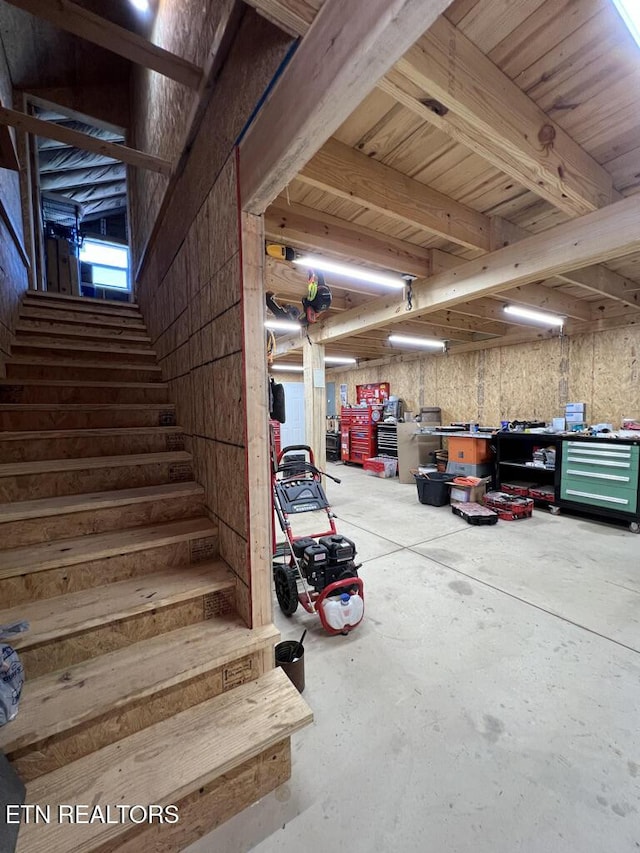 interior space with a workshop area and unfinished concrete flooring