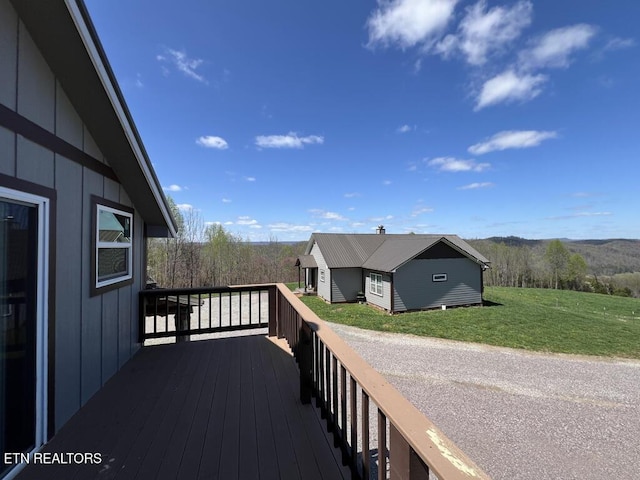 deck with a lawn and a mountain view