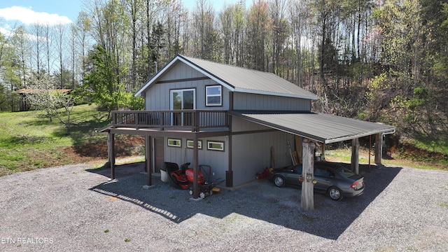 view of outbuilding featuring driveway and an attached carport