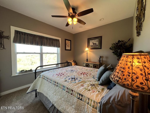 bedroom with carpet flooring, a ceiling fan, and baseboards