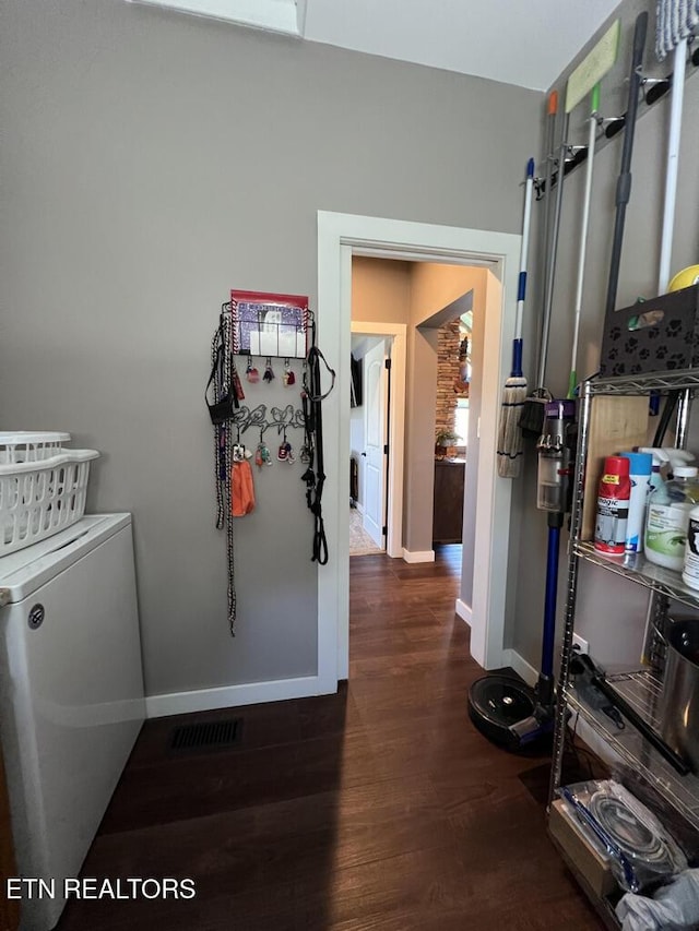 laundry area featuring laundry area, baseboards, wood finished floors, and visible vents