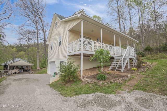 211 Peanut Ln, New Tazewell, TN 37825 - view of side of home with a carport, a porch, a garage, stairway, and driveway