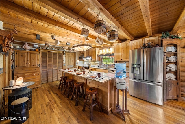 kitchen featuring light wood-style flooring, wood ceiling, light countertops, stainless steel appliances, and beam ceiling