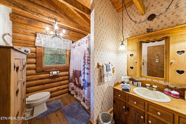 bathroom with log walls, toilet, vanity, wood finished floors, and vaulted ceiling with beams