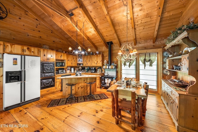 kitchen with white refrigerator with ice dispenser, an inviting chandelier, light wood-style floors, and wood ceiling