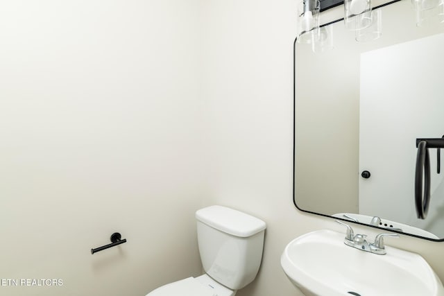 bathroom featuring toilet and a sink
