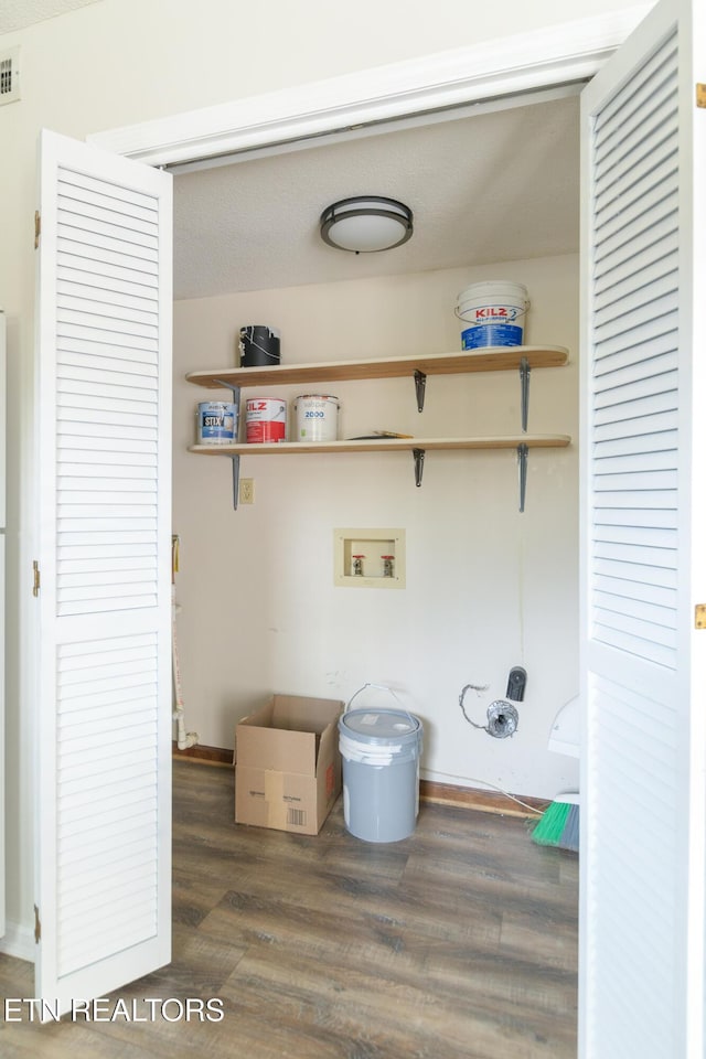 washroom featuring visible vents, laundry area, wood finished floors, and washer hookup