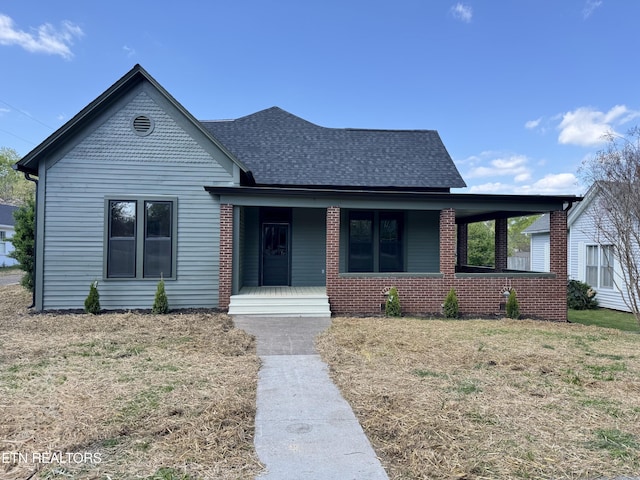 304 Broad St, Sweetwater, TN 37874 - bungalow-style home featuring brick siding, roof with shingles, a porch, and a front yard