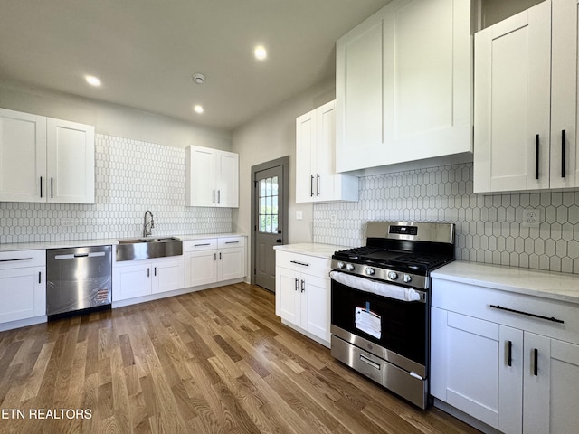 304 Broad St, Sweetwater, TN 37874 - kitchen featuring white cabinetry, appliances with stainless steel finishes, a sink, and backsplash