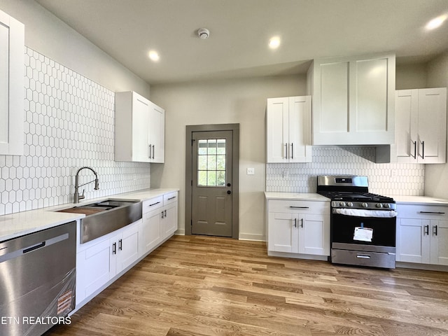 304 Broad St, Sweetwater, TN 37874 - kitchen featuring a sink, backsplash, light countertops, and appliances with stainless steel finishes