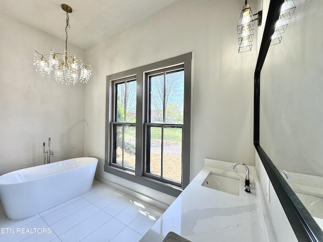 304 Broad St, Sweetwater, TN 37874 - full bath featuring a chandelier, a freestanding bath, vanity, and tile patterned flooring