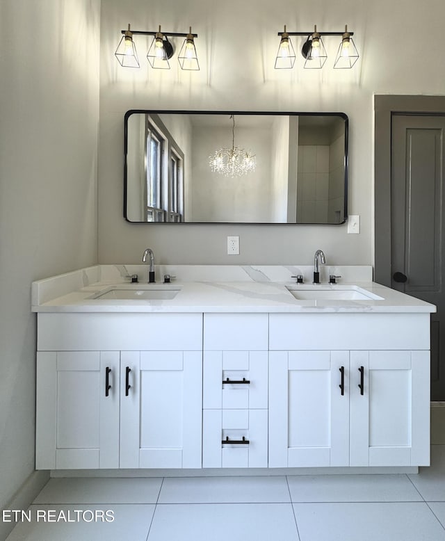 304 Broad St, Sweetwater, TN 37874 - bathroom featuring tile patterned floors, double vanity, a sink, and a notable chandelier