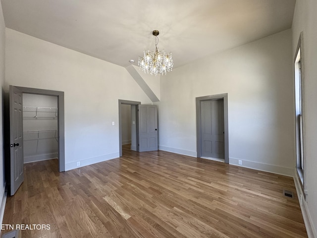 304 Broad St, Sweetwater, TN 37874 - unfurnished bedroom featuring visible vents, wood finished floors, a walk in closet, baseboards, and a notable chandelier