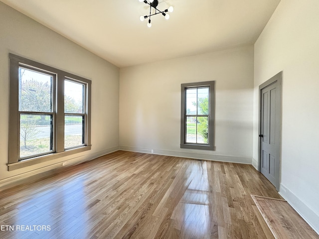 304 Broad St, Sweetwater, TN 37874 - unfurnished room with baseboards, a notable chandelier, and light wood-style floors