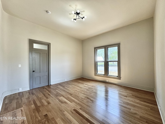 304 Broad St, Sweetwater, TN 37874 - unfurnished room with a notable chandelier, baseboards, and wood finished floors