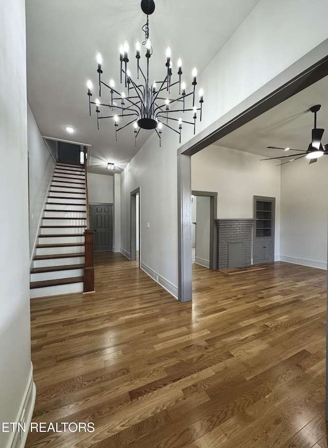 304 Broad St, Sweetwater, TN 37874 - interior space with baseboards, a high ceiling, stairway, wood finished floors, and ceiling fan with notable chandelier