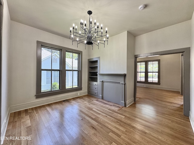 304 Broad St, Sweetwater, TN 37874 - unfurnished dining area with baseboards, plenty of natural light, a chandelier, and wood finished floors