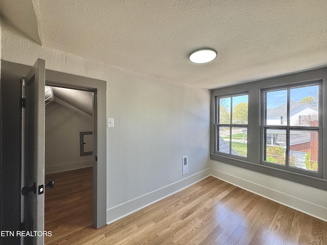 304 Broad St, Sweetwater, TN 37874 - spare room featuring a textured wall, light wood-type flooring, a textured ceiling, and baseboards