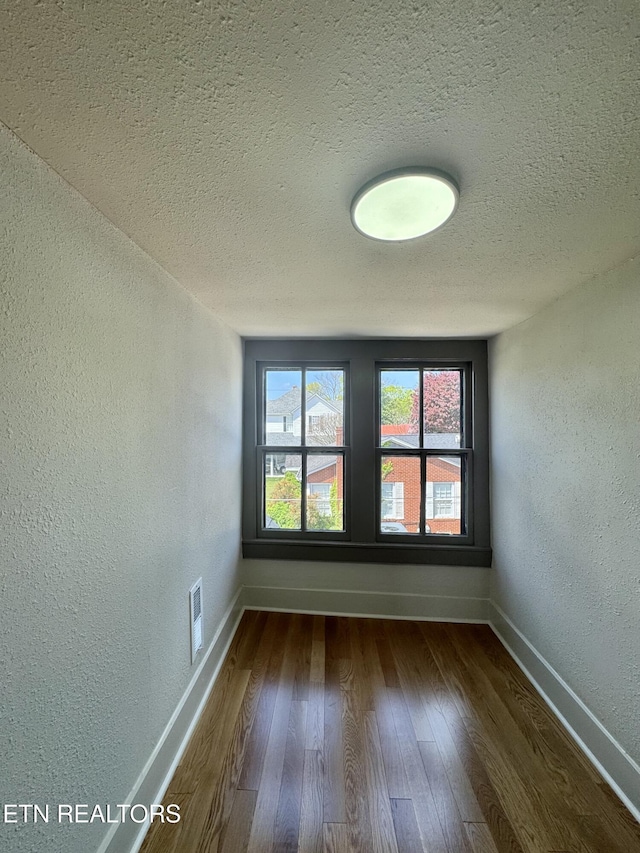 304 Broad St, Sweetwater, TN 37874 - unfurnished room featuring a textured wall, dark wood-type flooring, visible vents, and a textured ceiling