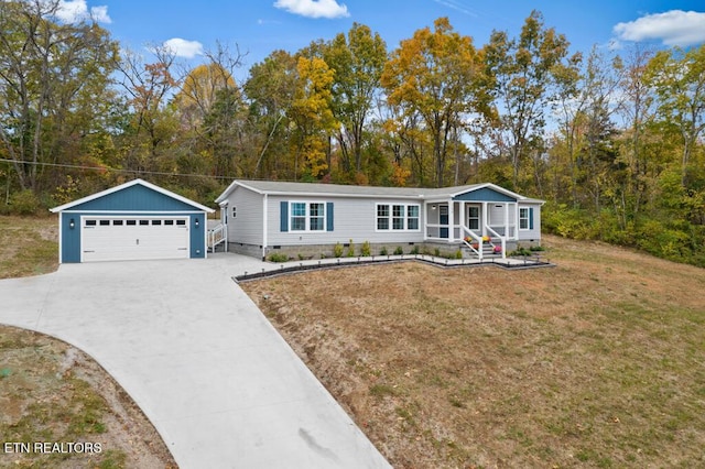 manufactured / mobile home featuring crawl space, a detached garage, an outdoor structure, entry steps, and a front yard
