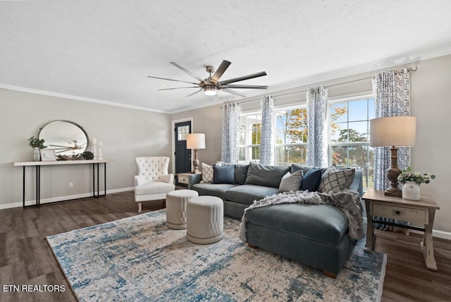 living area featuring a textured ceiling, a ceiling fan, ornamental molding, wood finished floors, and baseboards