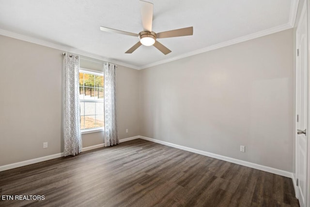 spare room featuring dark wood-type flooring, crown molding, baseboards, and a ceiling fan