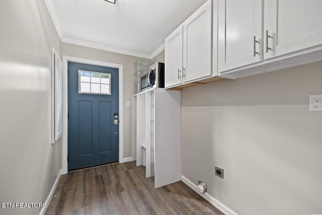 laundry area with crown molding, dark wood finished floors, electric dryer hookup, baseboards, and cabinet space