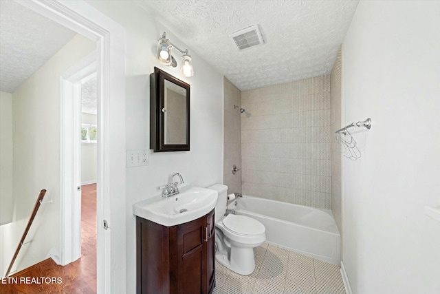 bathroom featuring visible vents, toilet, a textured ceiling, vanity, and shower / tub combination