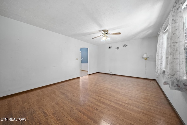 1615 Upper Middle Creek Rd, Sevierville, TN 37876 - unfurnished room with a textured ceiling, wood finished floors, ceiling fan, and baseboards
