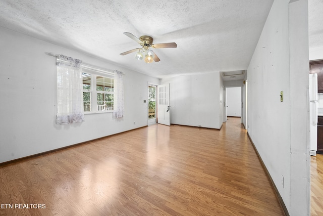 1615 Upper Middle Creek Rd, Sevierville, TN 37876 - unfurnished room featuring baseboards, a textured ceiling, attic access, ceiling fan, and light wood finished floors