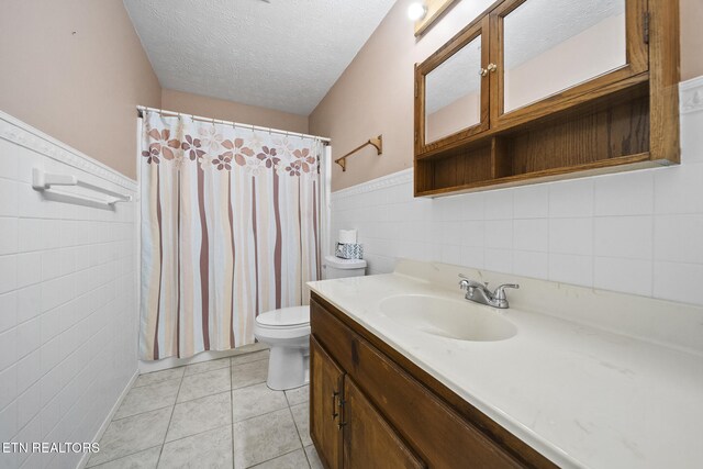 1615 Upper Middle Creek Rd, Sevierville, TN 37876 - full bathroom with vanity, wainscoting, tile walls, and toilet