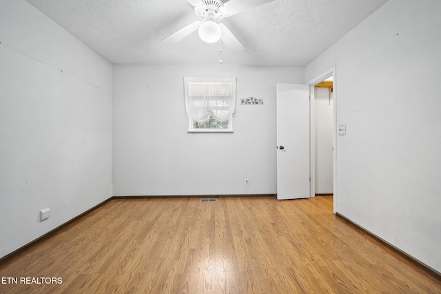 1615 Upper Middle Creek Rd, Sevierville, TN 37876 - spare room featuring baseboards, light wood-type flooring, a ceiling fan, and a textured ceiling