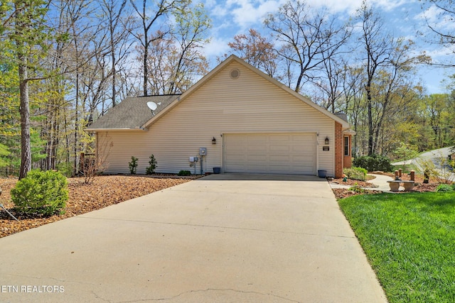 10 Claremont Cir, Fairfield Glade, TN 38558 - view of side of property with concrete driveway, an attached garage, and a yard