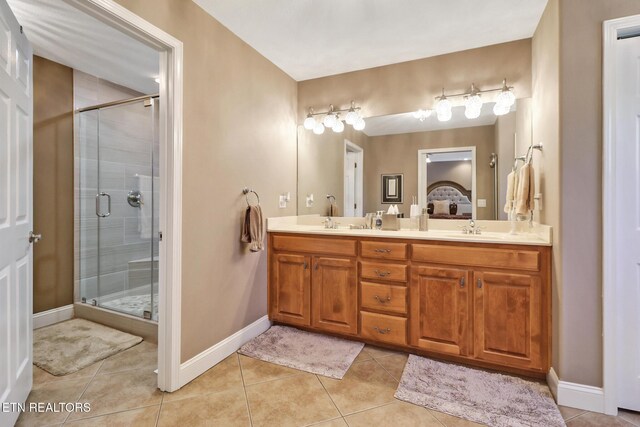 10 Claremont Cir, Fairfield Glade, TN 38558 - bathroom with a sink, tile patterned floors, a stall shower, double vanity, and baseboards