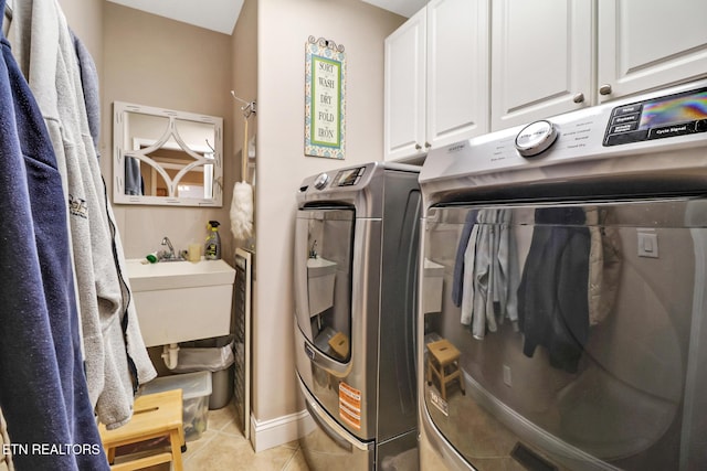 10 Claremont Cir, Fairfield Glade, TN 38558 - laundry area with washing machine and clothes dryer, a sink, light tile patterned floors, and cabinet space