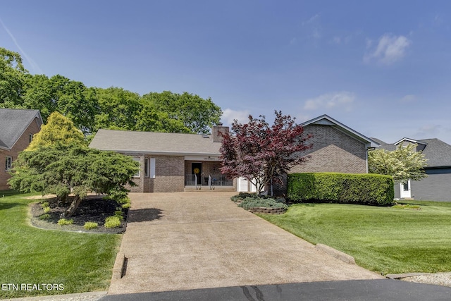 212 Tooweka Ln, Loudon, TN 37774 - ranch-style house featuring driveway, a front yard, brick siding, a chimney, and a garage