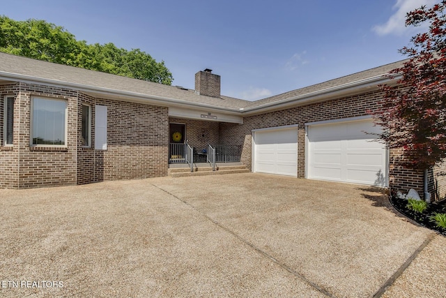 212 Tooweka Ln, Loudon, TN 37774 - ranch-style home with brick siding, driveway, a chimney, and a garage